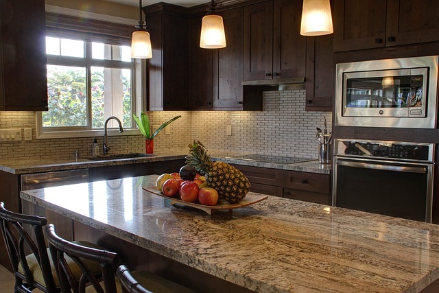 Modern dark kitchen with stone counters.  Helotes Remodeling Contractors can update your kitchen to match your vision